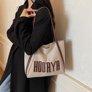 Minimalist canvas tote bag with brown leather straps and HOOAYA lettering for women