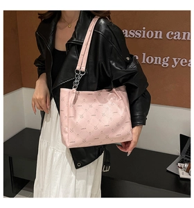 Pink printed tote bag detail featuring repeating rabbit patterns and silver chain shoulder strap