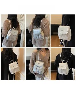 Detail shots of a mini silver and white backpack showing fit and chain accents