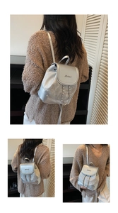 Detail showing the silver metallic PU backpack with cat print and metal chain strap