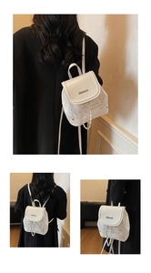 Detailed view of white PU leather mini backpack with cat print and chain strap