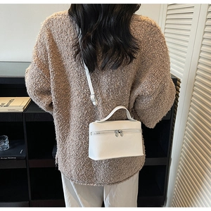 Minimalist white pebbled leather box bag styled with a khaki knitted sweater