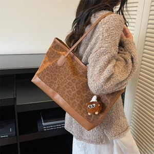 Retro leopard print tote bag with brown leather straps and furry monster keychain charm