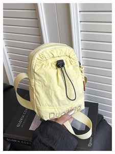 Détail du sac bandoulière en nylon jaune clair avec broderie Duoning et cordon de serrage