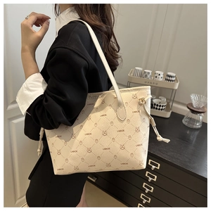 Detail of off-white tote bag with rabbit print and decorative side drawstring design