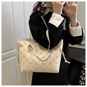 Detail of cream white tote bag featuring rabbit print and drawstring side accents