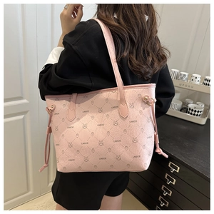 Detail view of pink leather tote bag with rabbit print and LNBOE lettering on shoulder