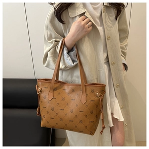 Close-up of brown tote bag with cartoon rabbit print and drawstring side detail