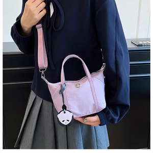 Detailed view of light purple nylon mini tote bag with panda charm and shoulder strap