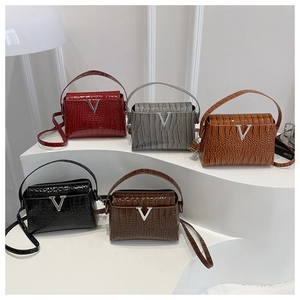 Detailed view of crocodile pattern leather handbags in five colors with V-shaped metal buckle