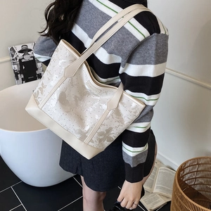 Chic cream tote bag with elegant butterfly prints and dual shoulder straps