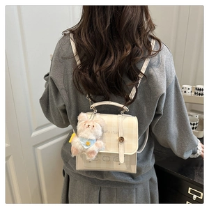 Model wearing a mini beige plaid backpack with cute bear prints and a plush pendant