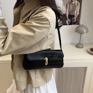 Elegant black crocodile pattern underarm bag with a gold rectangular metal buckle