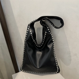 Retro black leather tote bag with silver rivets and wide shoulder strap in rock style