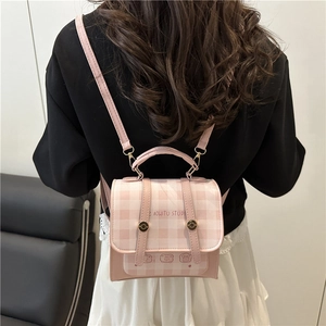 Pink and white plaid mini backpack with cartoon bear graphic and adjustable straps