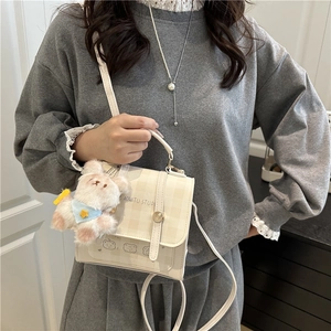 Beige checkered mini backpack with cute bear pendant and top handle for women