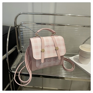 Detail of pink plaid small backpack with cute bear print and buckle straps