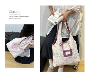 Detail of floral tote bag showing blue checkered lining and decorative bow closure