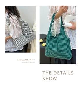 Detail of gingham tote bag with floral lining and decorative bow tie closure