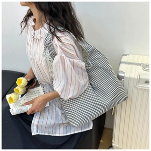 Close-up of large capacity black and white checkered canvas tote bag for daily travel