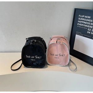 Close-up of mini leather backpacks in black and pink with stylish letter printing