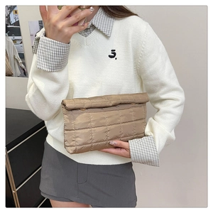 Close-up of khaki quilted envelope clutch bag with premium stitching and texture