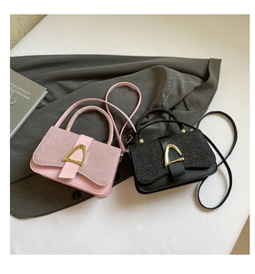 Detail of pink and black glitter patchwork handbags with gold triangle buckles and straps