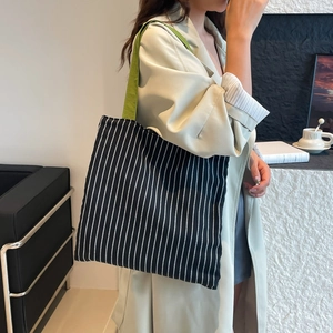 Casual black and white striped canvas tote bag with green shoulder strap for women
