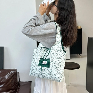 Large floral canvas tote bag with green checkered pocket and elegant bow accent