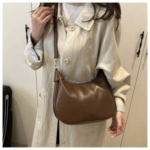 Retro brown PU leather half-moon hobo bag styled with a classic autumn trench coat