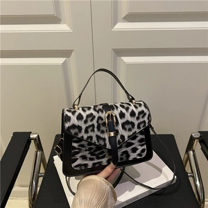 Fashionable leopard print structured crossbody bag with black leather and metallic buckle