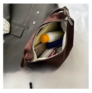 Internal view of the brown suede crossbody bag showing large storage capacity