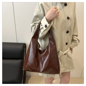 Détail du grand sac cabas marron foncé avec une texture souple et une large bandoulière