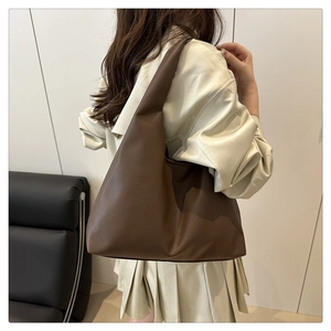Detail of soft dark coffee litchi grain leather hobo bag with seamless shoulder strap