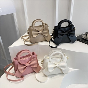 Chic women's crossbody bag collection featuring oversized bows in four elegant colors
