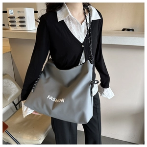 Fashionable dark grey large capacity shoulder bag with unique braided strap and logo detail