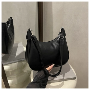 Detailed shot of black leather hobo bag with silver metal hardware and smooth finish
