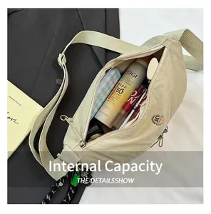 Close-up of cream nylon crossbody bag interior showing spacious capacity for daily items