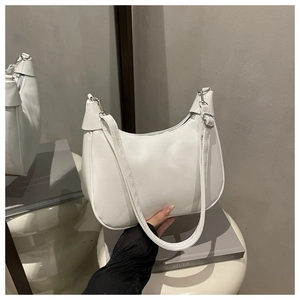 Close-up of white semi-circle saddle bag with adjustable strap and silver hooks