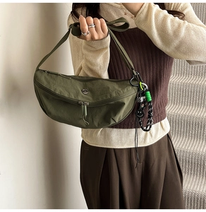 Olive green lightweight nylon crescent crossbody bag with braided rope and zip detail