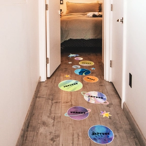 Detailed floor view of solar system planet stickers including Earth and Mars in a hallway