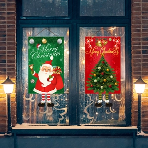 Close-up of festive Christmas hanging banners with 3D legs against a snowy window