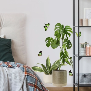 Bedroom wall decor featuring realistic monstera and snake plant stickers with 3D butterflies