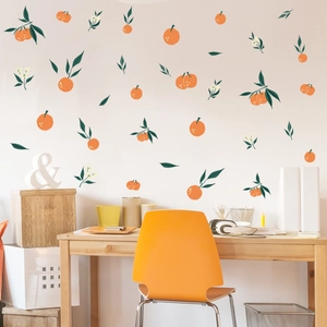 Vibrant orange wall stickers with green leaves and white flowers in a cozy home office setting