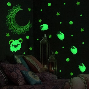 Luminous wall stickers featuring moon and sheep in a dark bedroom glow effect