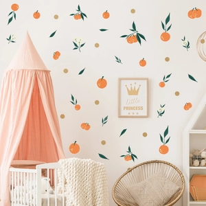 Detail showing orange and leaf wall stickers in a cozy Nordic nursery with a crib
