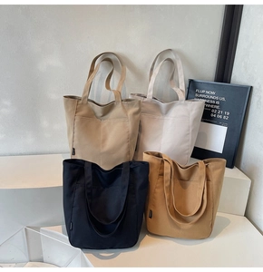 Detail showing four minimalist canvas tote bags in khaki, white, navy, and brown colors