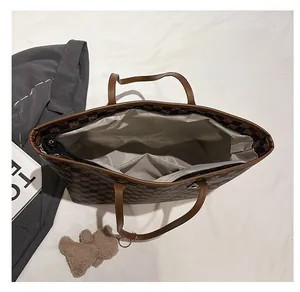 Top view of large tote bag interior showing brown checkered texture and inner pocket