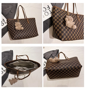 Detail view of large retro tote bag with brown checkerboard pattern and bear charm