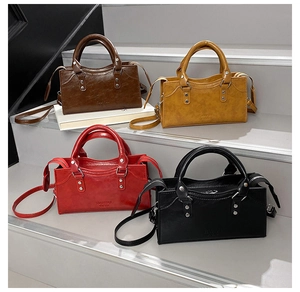 Detail view of vintage PU leather handbags in four colors with silver rivets